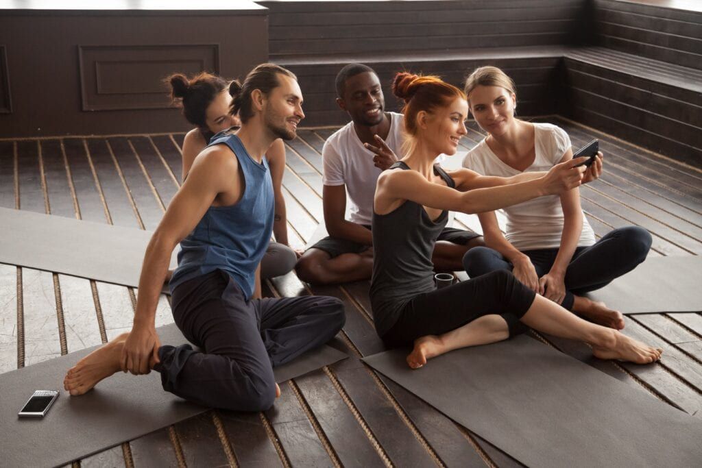 Pilates studio business owner taking a selfie with her team of instructors.