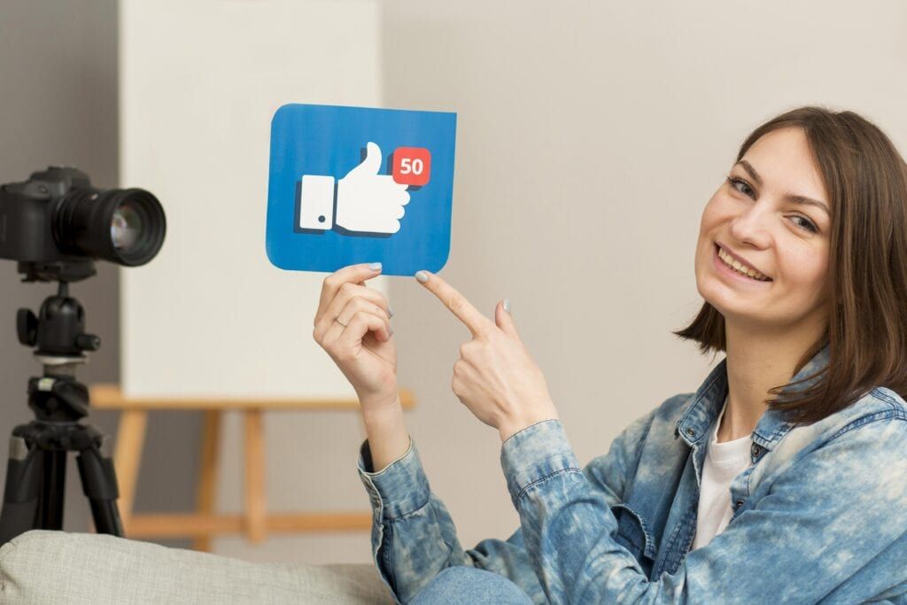 Portrait of a woman showing Facebook likes