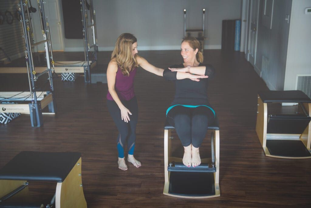 Laurie Sindlinger, Pilates teacher teaching Pilates exercise with her client