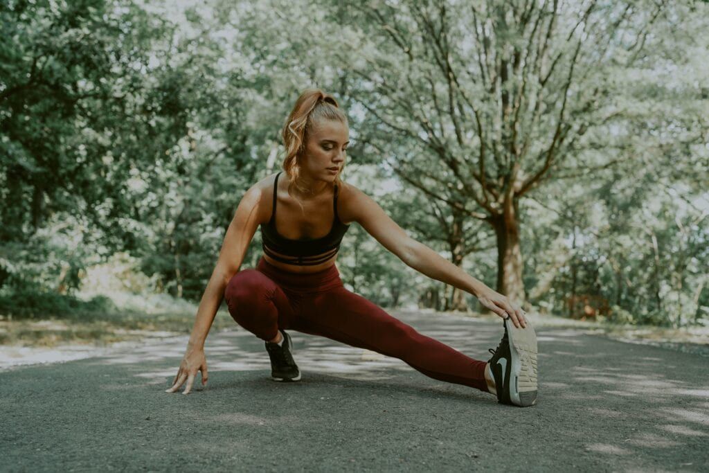 Woman working out on Pilates retreat with trees in the background